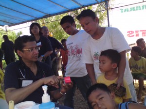 Dr Thambiah speaking to a patient..